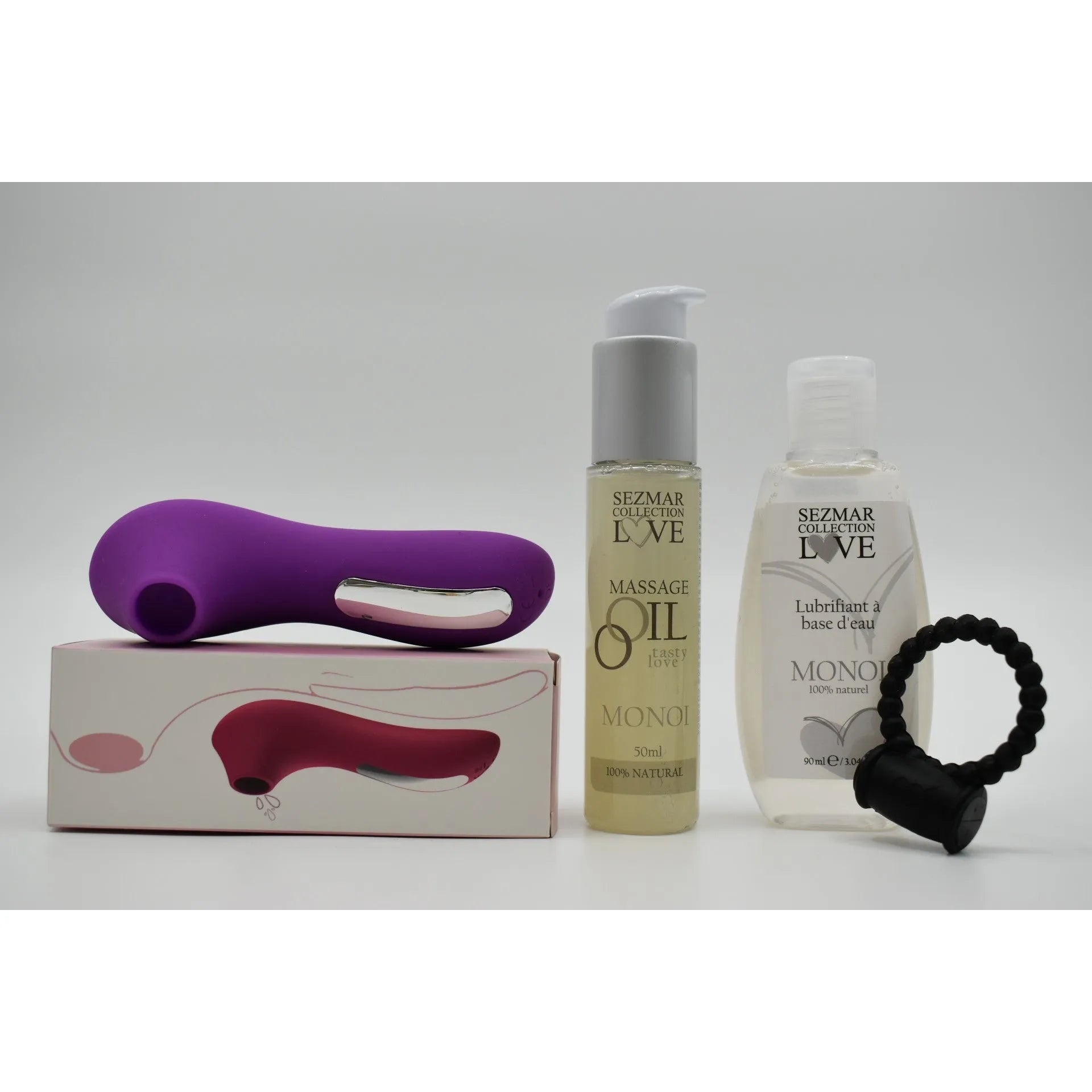 Stimulateur violet, huile de massage Monoï, anneau vibrant noir, et lubrifiant, dans une box couple été.
