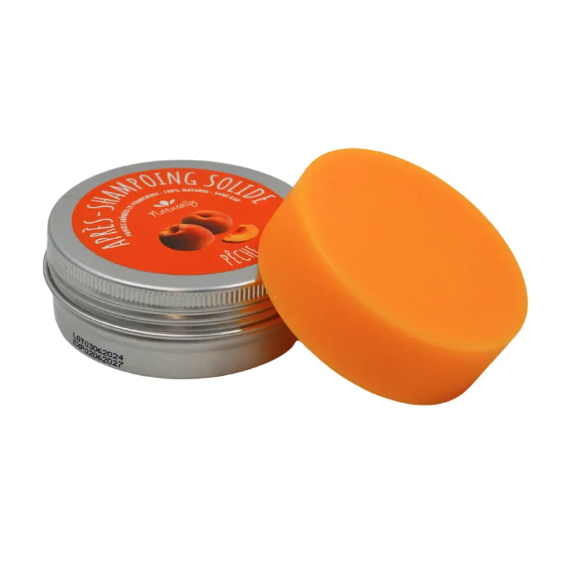 Après-shampoing solide orange mangue pêche, boîte métallique, soin cheveux abîmés, brillance et douceur.
