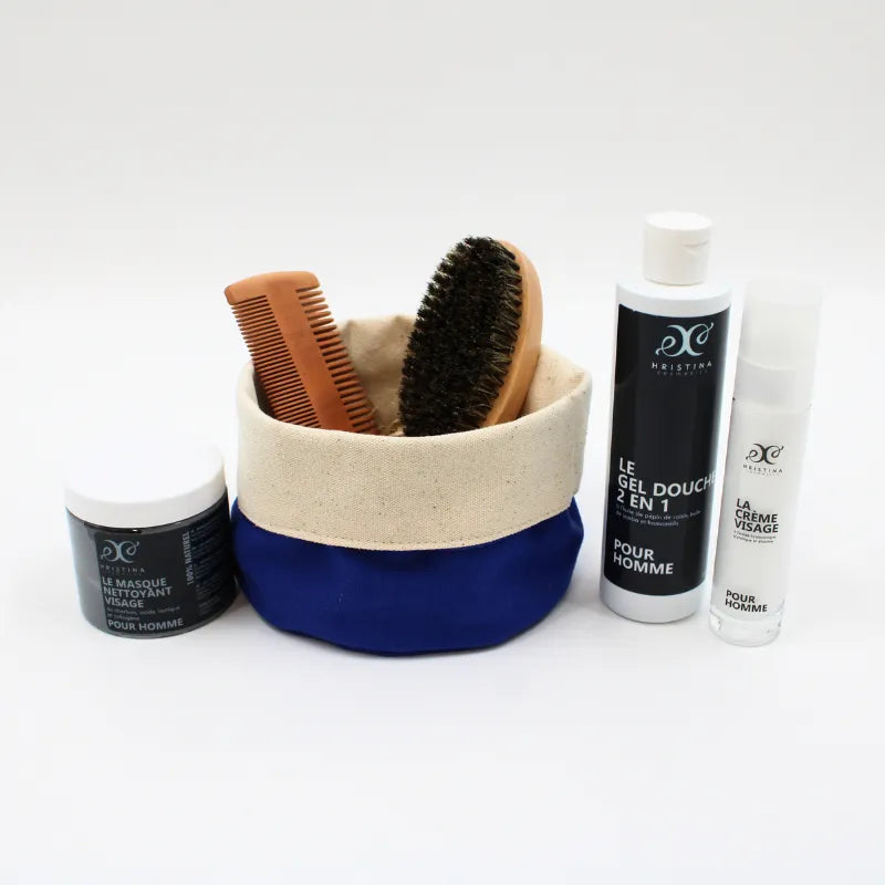 Coffret soins visage barbe homme, produits naturels hydratants, parfum boisé, brosse, peigne, flacons blancs, pochette bleue.