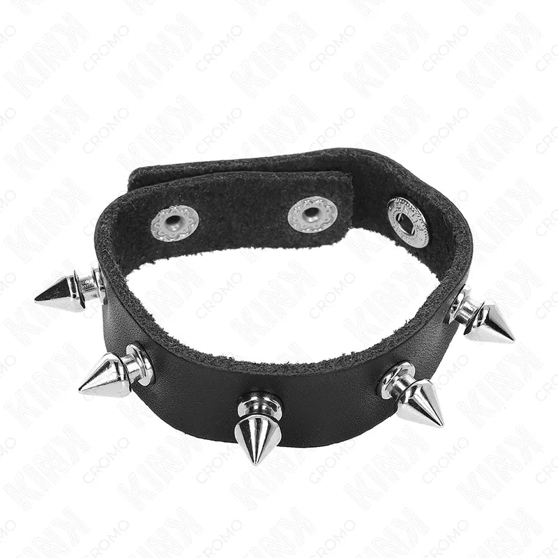 Anneau pénien BDSM cuir noir ajustable avec clous, élégant et confortable pour stimulation intense et contrôle sécurisé.