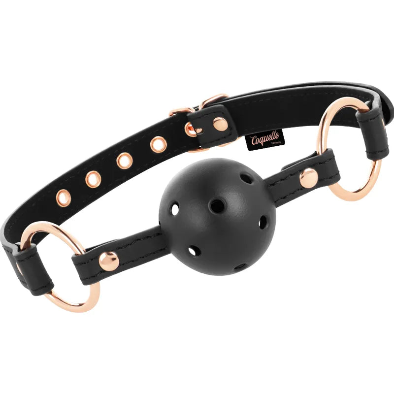 Bâillon cuir vegan noir avec boule néoprène perforée, attaches réglables en métal doré, design confortable et sécurisé.