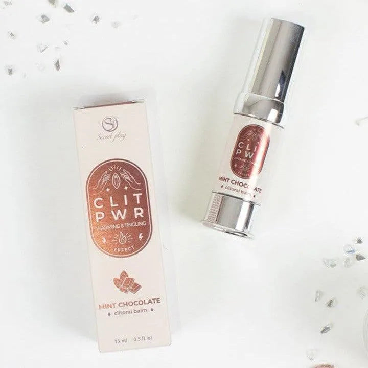 Baume chauffant clitoris menthe chocolat, flacon argenté, boîte rose, stimulation sensibilité, texture soyeuse.