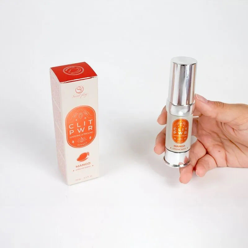 Flacon argenté de baume stimulant clitoridien mangue avec boîte orange, effet chauffant et vibratoire pour plaisir intense.