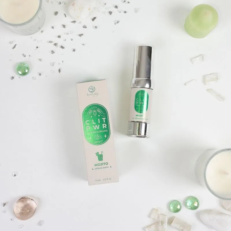 Baume stimulant clitoris chauffant, flacon argenté 15ml, boîte blanche et verte, ambiance intime et élégante.