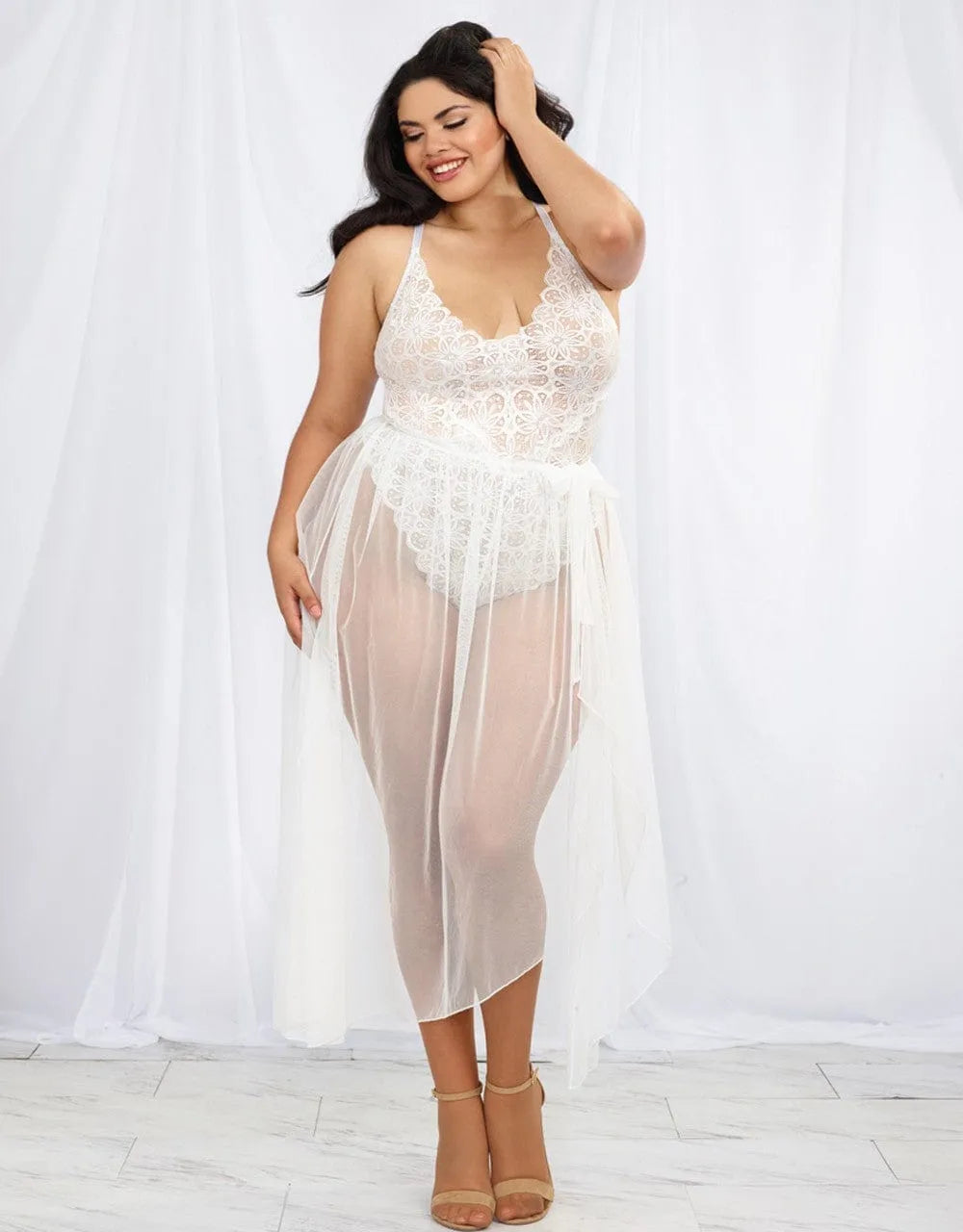 Body grande taille dentelle blanche, coupe échancrée, dos nu, bretelles réglables, jupe longue maille transparente.