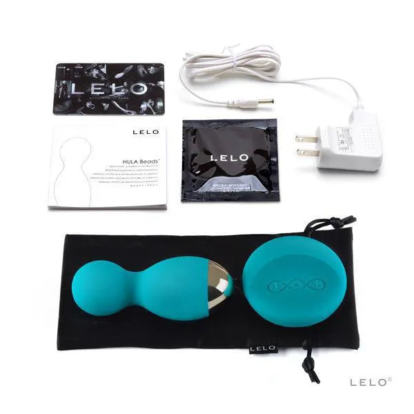 Boules vibrantes bleues avec télécommande, câble USB, chargeur, lubrifiant, sac satin noir, manuel et carte LELO.