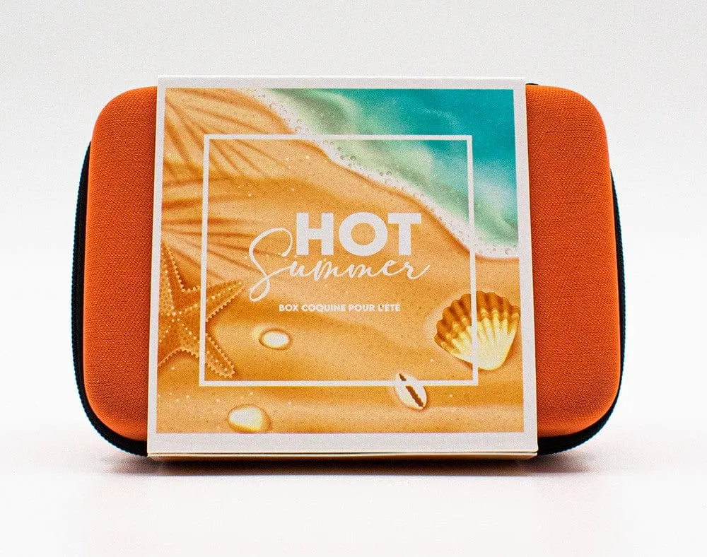 Coffret orange Box Hot Summer avec stimulateur, anneau vibrant, huile Monoï, lubrifiant naturel, plage illustrée.