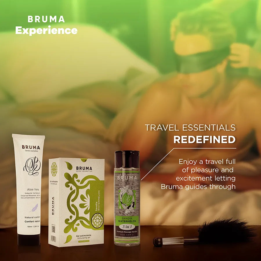 Gel lubrifiant fraise, huile massage, plume noire, coffret sensualité BRUMA, fond vert, ambiance intime et élégante.