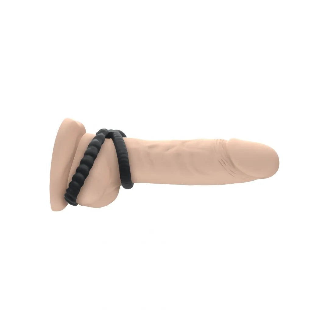 Anneau silicone noir double stimulation, flexible, cannelé, pour pénis et testicules, confort étanche, érections longues.