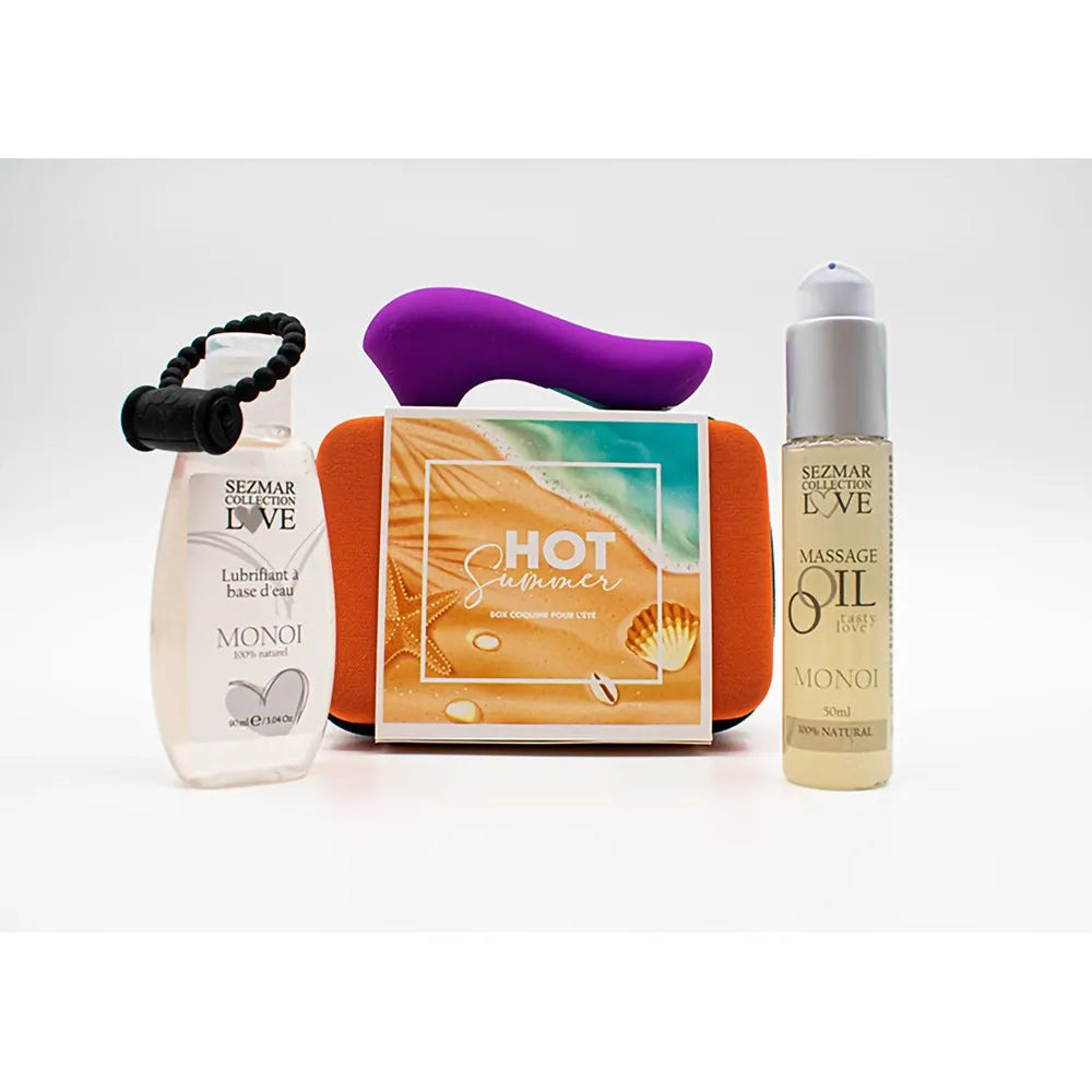 Box Couple Été avec stimulateur violet, anneau noir, huile de massage Monoï et étui rigide orange, pour moments intimes.