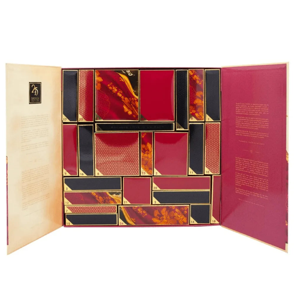 Calendrier de l'avent Shunga 25 ans, coffret or et pourpre, 25 cases, design luxueux, produits bien-être intime.