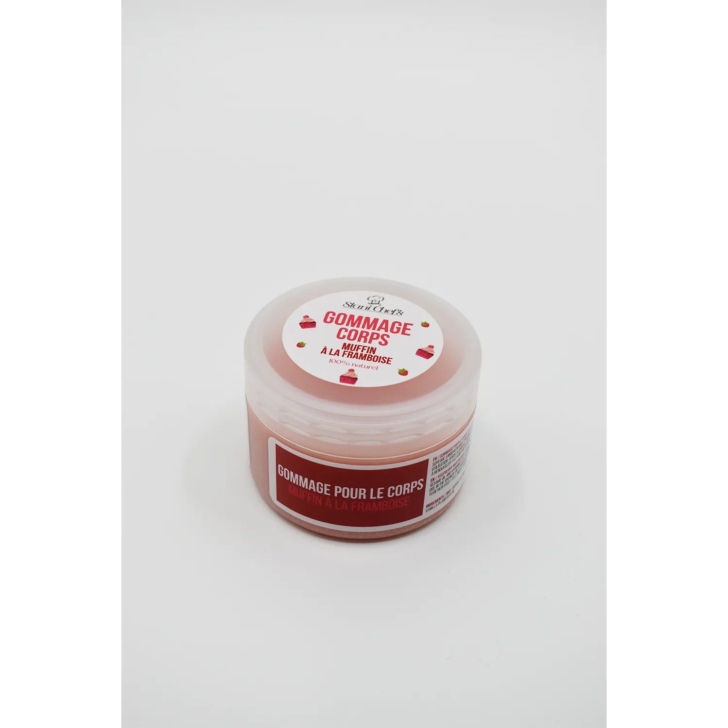 Pot rose de gommage corps naturel muffin framboise, 100ml, avec couvercle blanc et étiquette illustrée de framboises.