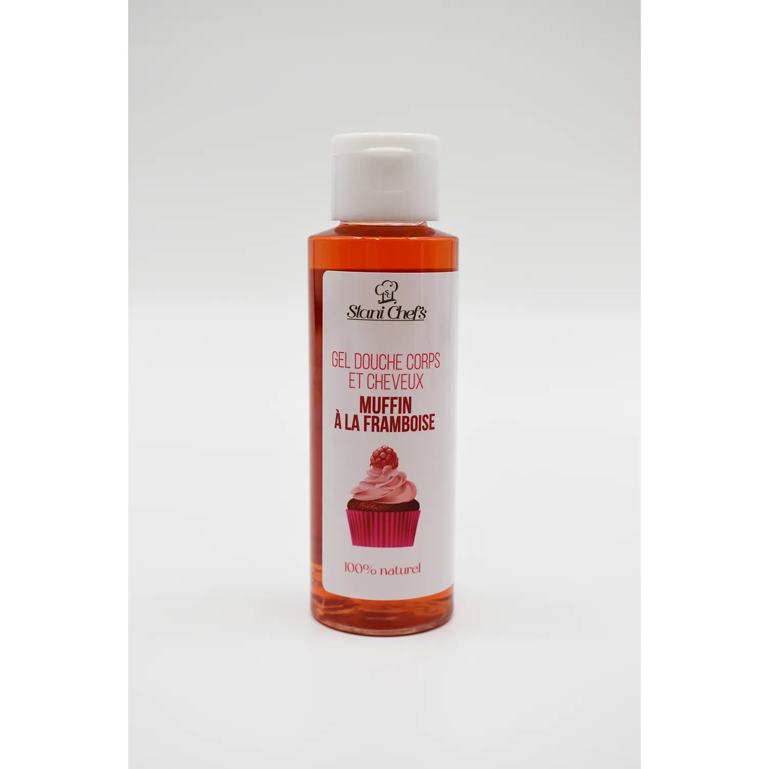 Flacon de gel douche shampoing bébé 100ml, couleur framboise, étiquette muffin, hydratant naturel pour peaux délicates.