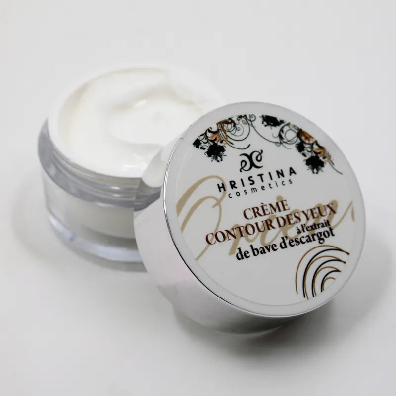 Crème contour yeux anti-âge bave escargot, pot blanc et argent, texture onctueuse, pour peaux matures et sensibles.