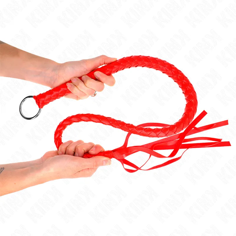 Cravache en cuir rouge tressé avec poignée ergonomique, anneau métallique et lanières, accessoire BDSM luxe et durable.