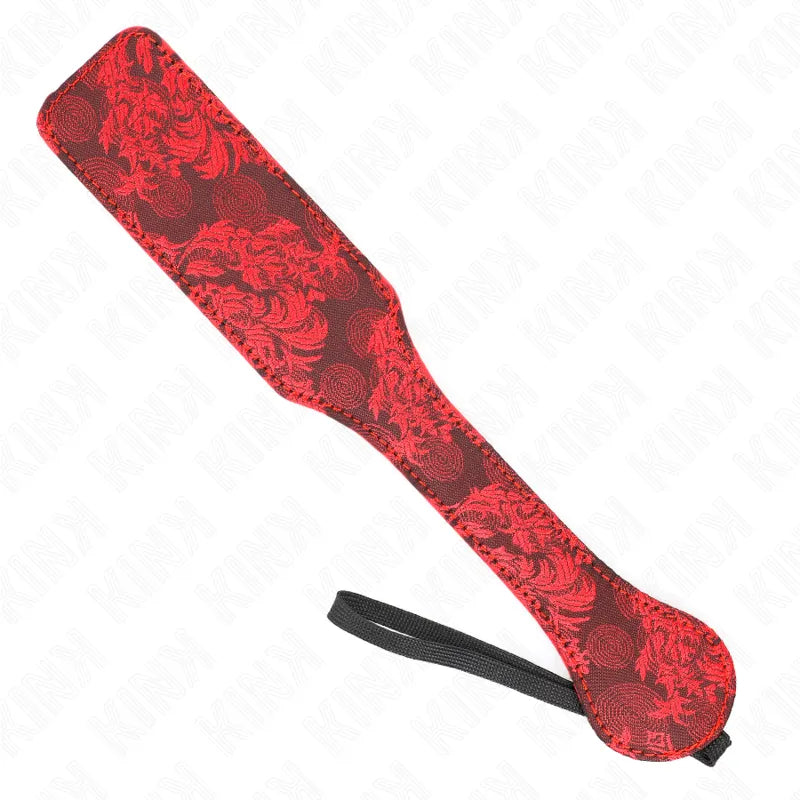 Pagaie BDSM en cuir rouge et noir, motifs floraux, poignée ergonomique, accessoire luxueux et personnalisable.