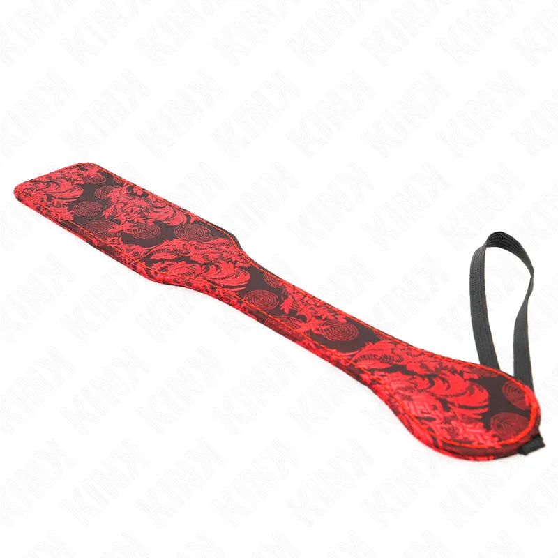 Pagaie BDSM en cuir rouge et noir, motif floral, artisanale, durable, ergonomique, pour expériences sensorielles luxueuses.