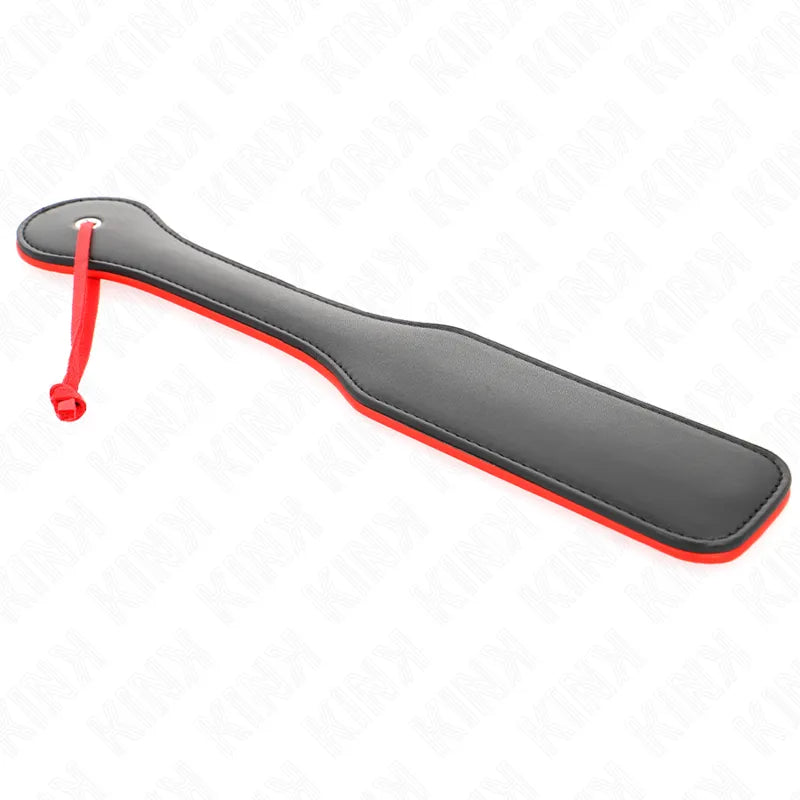 Accessoire BDSM en cuir noir et rouge, pagaie élégante et durable pour expériences sensuelles et raffinées.