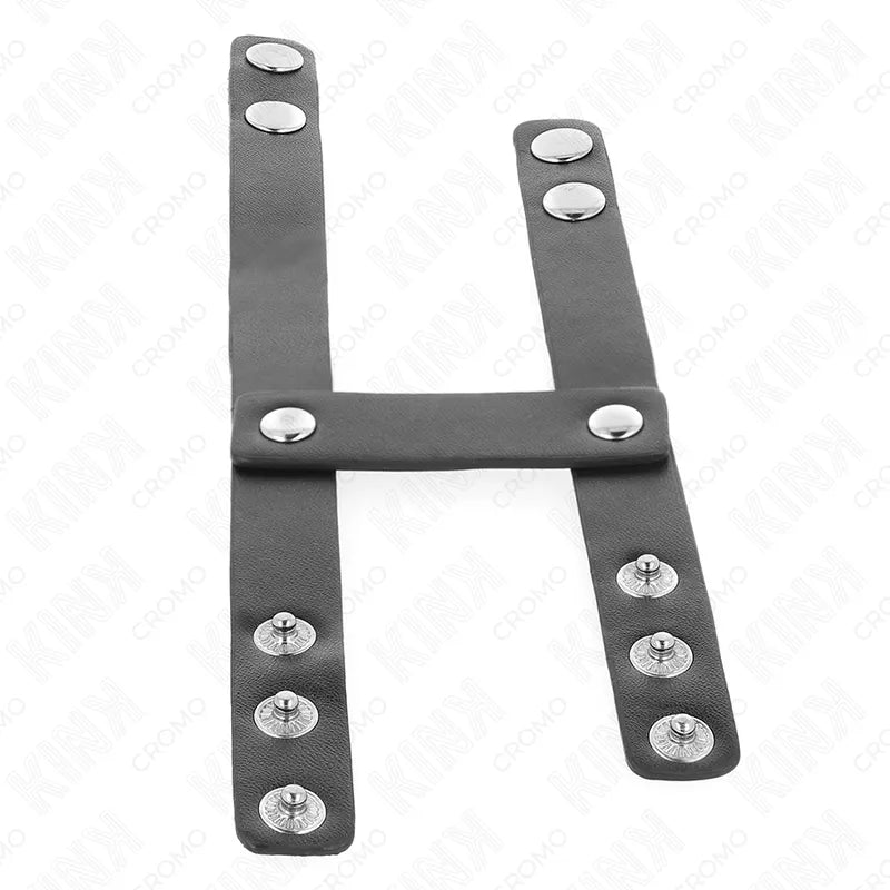 Anneau pénien cuir noir réglable avec boutons pression, design sophistiqué pour expériences BDSM intenses et personnalisées.