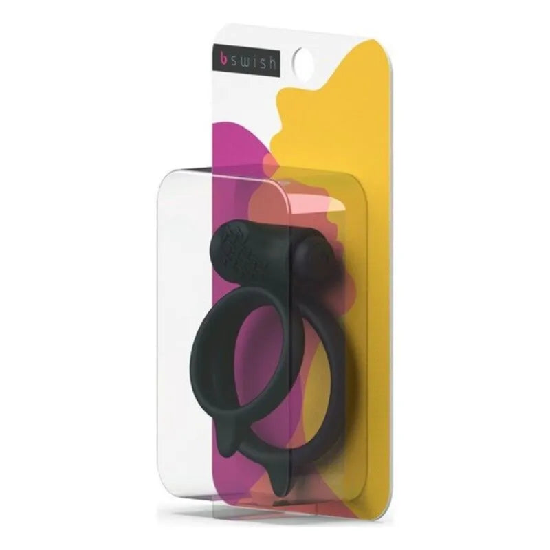 Anneau pénien noir texturé vibrant en silicone, compact et ergonomique, emballé dans un étui transparent coloré.