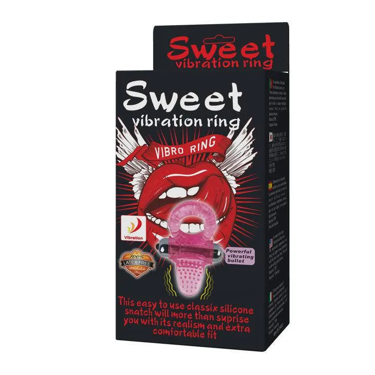 Anneau vibrant rose ergonomique avec stimulateur clitoridien intégré, balle amovible, sur fond d'emballage noir.