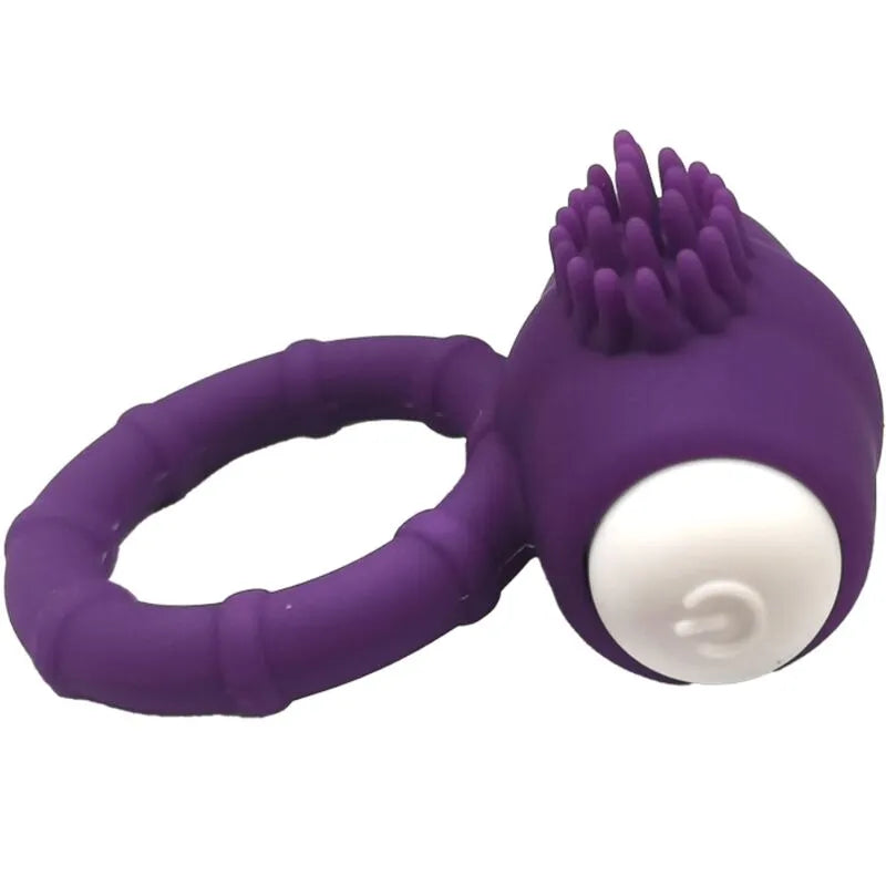 Anneau vibrant violet en silicone médical submersible, design ergonomique, surface texturée, bouton blanc, piles incluses.