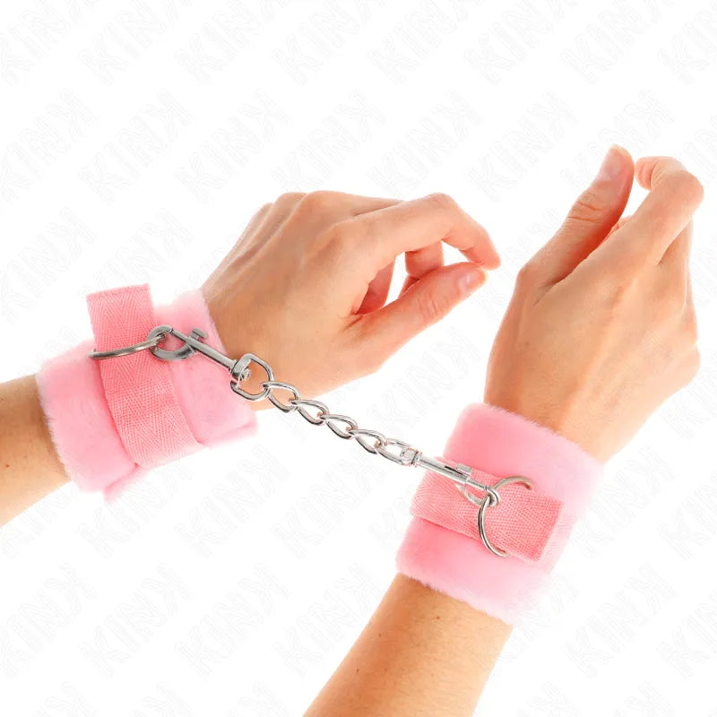 Bandes poignets BDSM rose en cuir végétalien, rembourrées, ajustables, avec chaîne métallique, confortables et esthétiques.