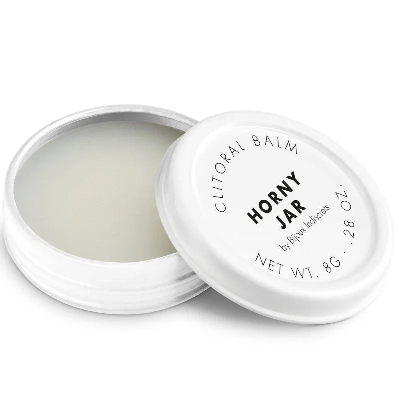 Baume clitoridien chauffant dans un pot blanc compact, texture soyeuse, idéal pour intensifier le plaisir intime.
