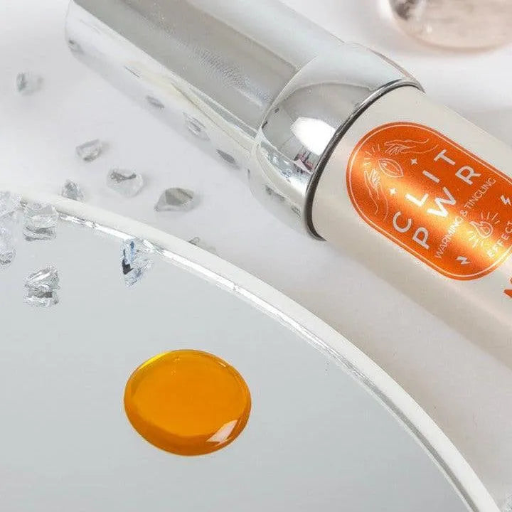 Baume clitoridien stimulant mangue, flacon argenté, goutte orange, intensifie sensations, chaleur et vibration.