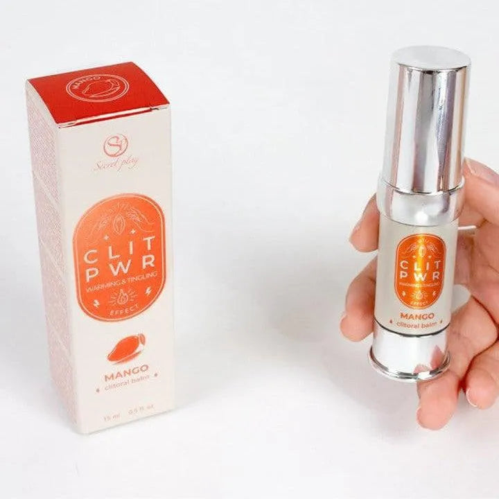 Flacon argenté de baume clitoridien mangue avec boîte orange, stimulant chaleur et vibration pour orgasmes puissants.
