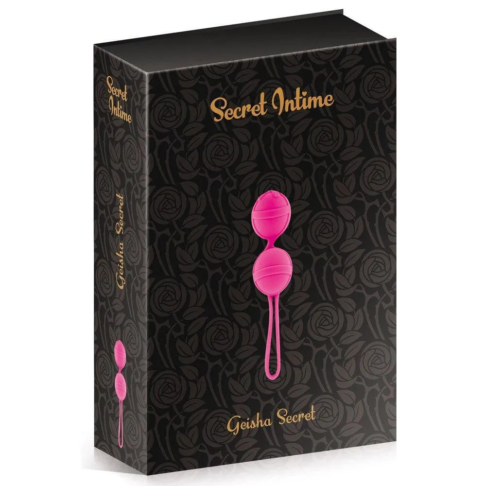 Boules de Geisha fuchsia en silicone souple, étanches, dans une boîte compacte noire à motifs floraux.