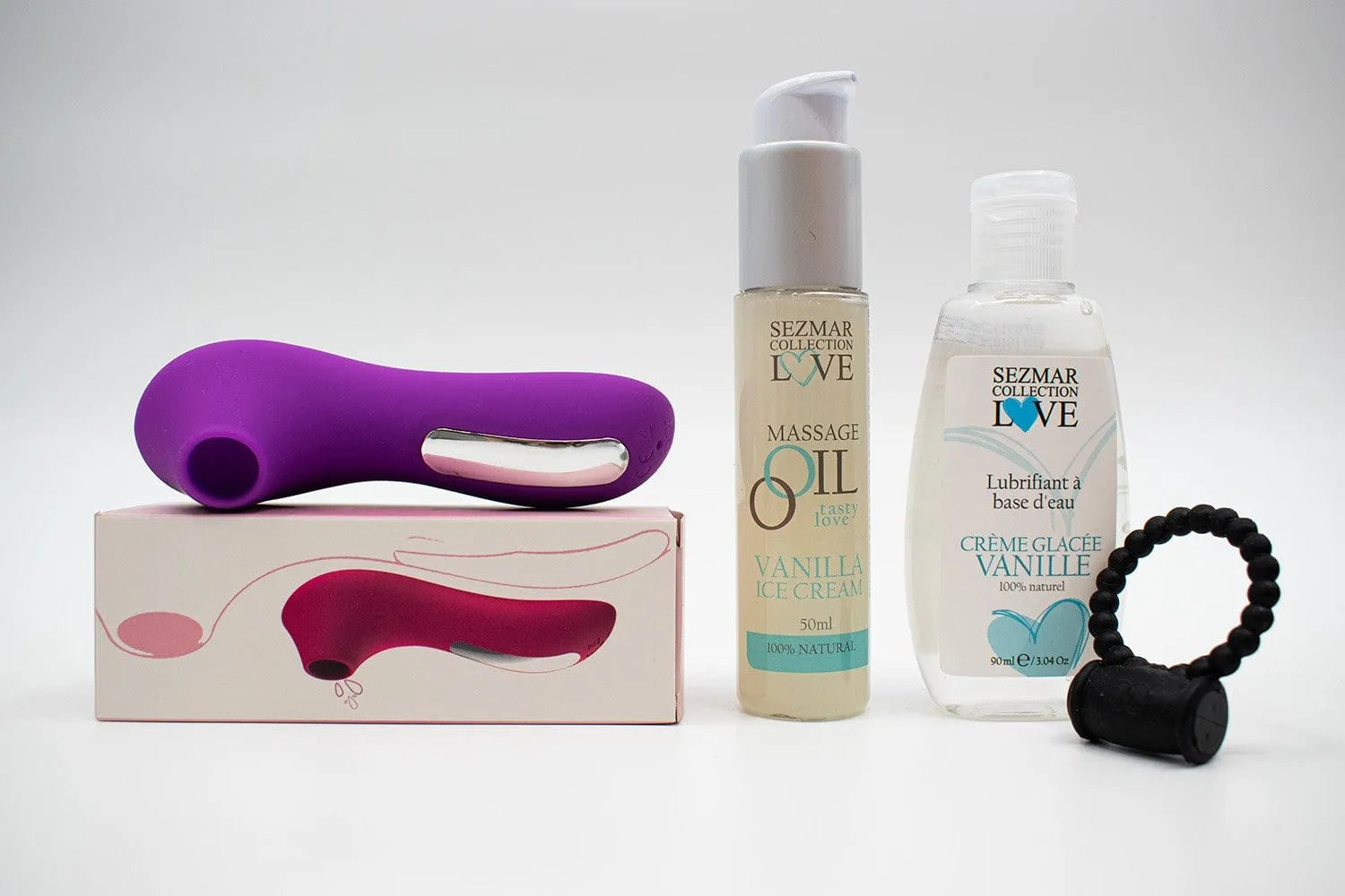 Coffret couple vanille: stimulateur violet, anneau vibrant noir, huile massage et lubrifiant vanille, boîte zippée.