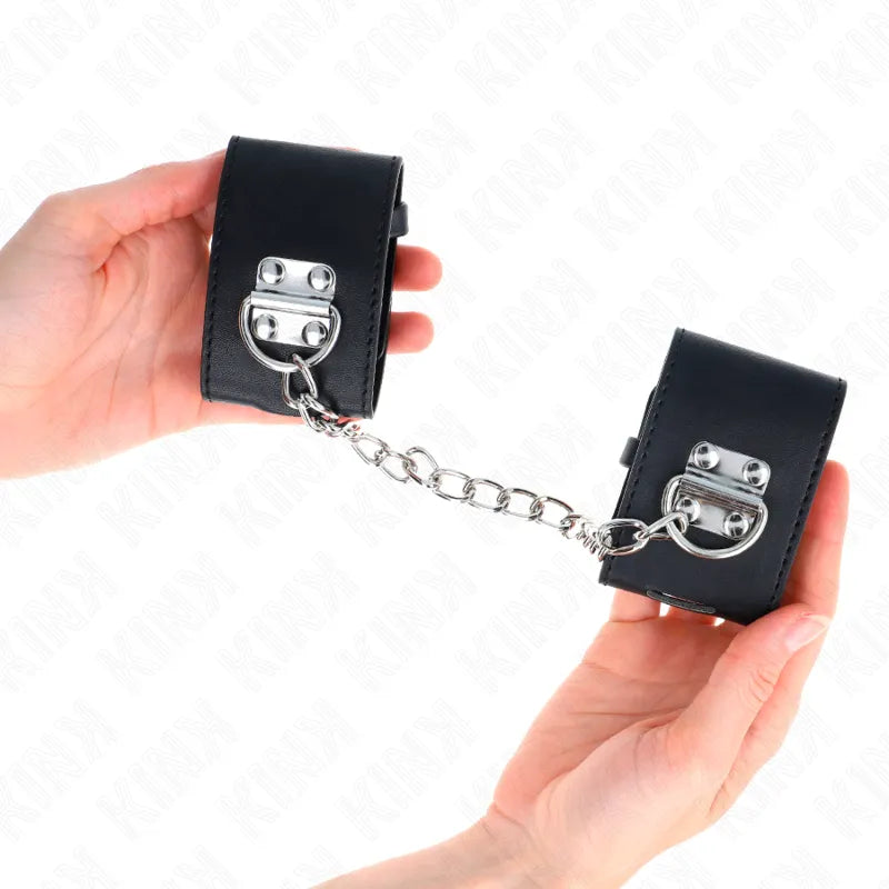 Bracelets BDSM en cuir noir avec boucles métalliques, chaîne robuste, design élégant et confortable pour jeux sécurisés.