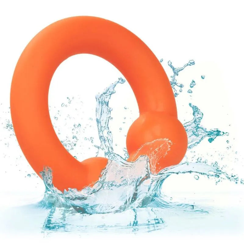 Anneau pénien orange en silicone liquide avec double boule, texture lisse, immergé dans l'eau pour confort et stimulation.