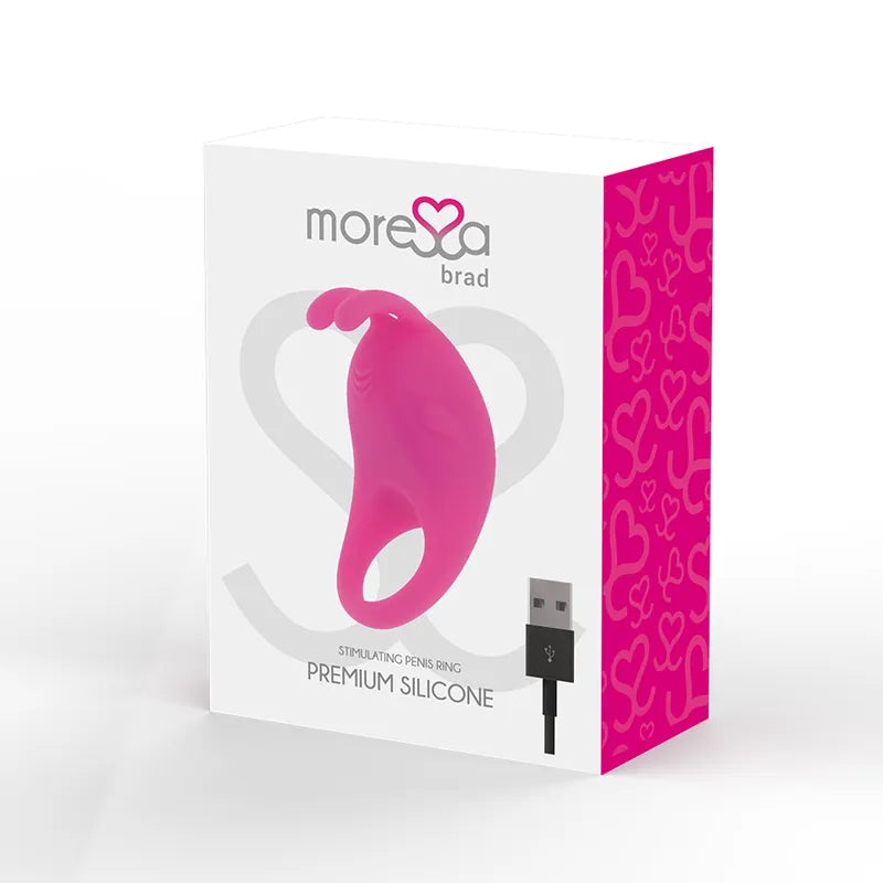 Anneau vibrant rose en silicone médical, rechargeable, sur boîte blanche et rose avec motif cœur, câble USB inclus.