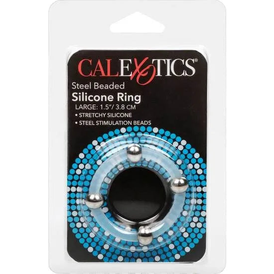 Anneau pénien silicone bleu perlé acier inoxydable, élastique et stimulant, sur fond d'emballage blanc et bleu.
