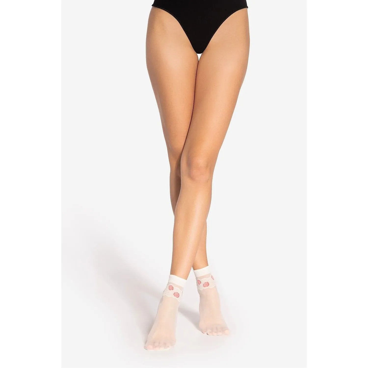 Chaussettes hautes transparentes avec dentelle fleurs roses, élégantes et sensuelles, portées par une femme.