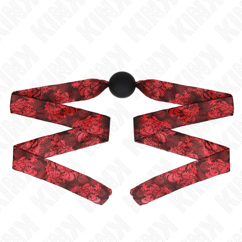 Gag BDSM en silicone noir avec sangle rouge ajustable, design ergonomique et élégant, idéal pour confort et sécurité.