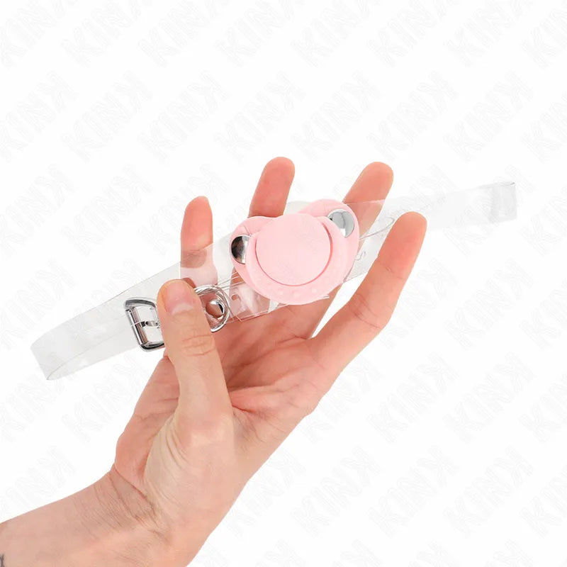 Bâillon boule rose en silicone hypoallergénique avec sangles réglables transparentes, ergonomique et sécurisé.