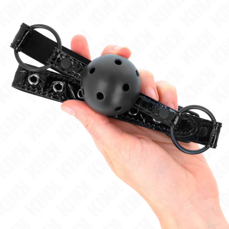 Bouchon silicone noir ajustable avec bille perforée, sangle en cuir noir, pour confort et sécurité BDSM.
