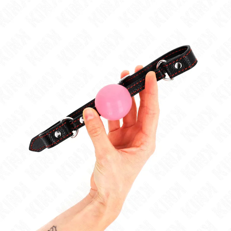Bâillon BDSM silicone rose, sangle noire ajustable, ergonomique, confort optimal, exploration sécurisée, moments intimes.