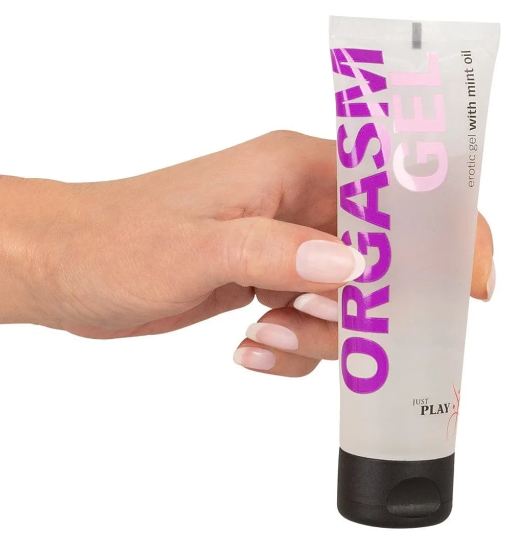 Gel clitoridien intensifiant mentholé dans un tube transparent avec bouchon noir, texte violet Orgasm Gel.