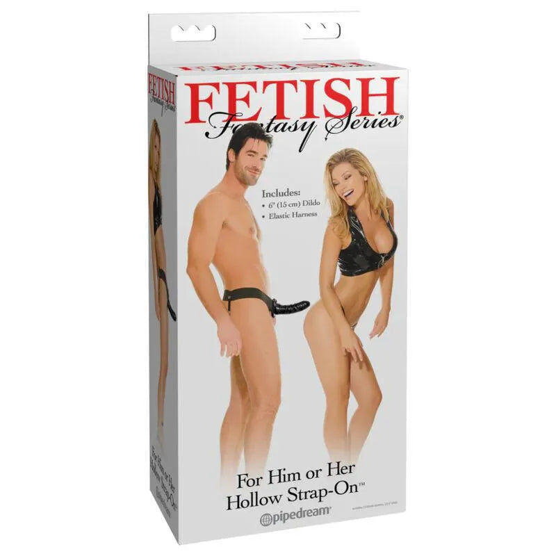 Gode-ceinture creux noir 15cm avec harnais élastique ajustable, emballage blanc avec couple souriant en arrière-plan.