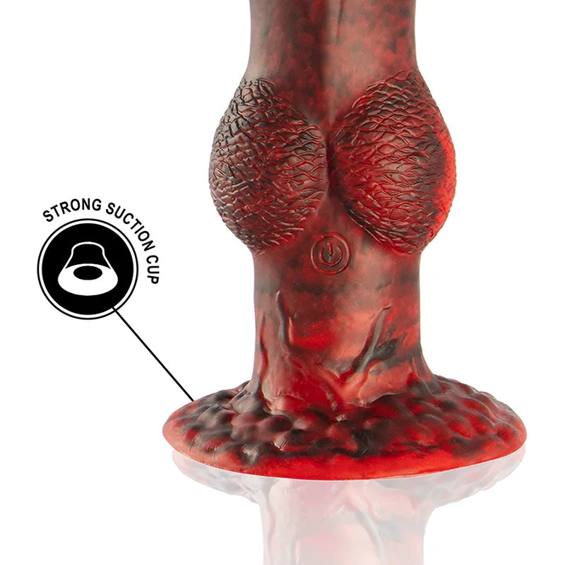 Gode vibrant rouge mythologie grecque en silicone, texture écaille, base ventouse, bouton marche/arrêt visible.