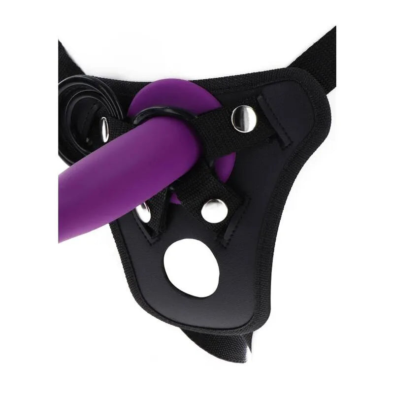 Harnais noir avec anneaux en silicone violet, bretelles réglables et pochette vibrante, matériaux doux et durables.
