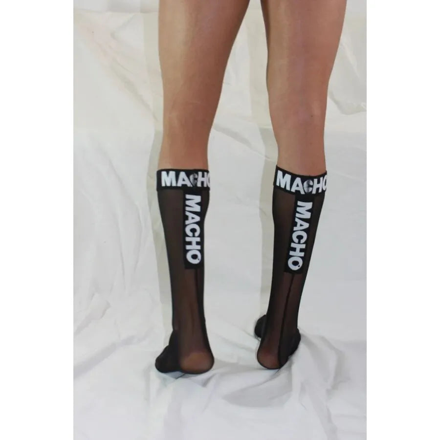 Chaussettes noires semi-transparentes macho, hautes, élastiques, avec texte blanc, pour style audacieux et élégant.